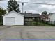 Detached garage featuring a car port and a secure fenced in backyard at 1618 California St, Columbus, IN 47201