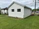 View of the exterior of the garage with the white siding and the green grass surrounding the building at 1618 California St, Columbus, IN 47201