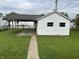 Garage featuring a car port has back yard access and parking solutions at 1618 California St, Columbus, IN 47201