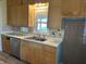 Kitchen with light wood cabinets, stainless appliances, white countertops, and brown tile backsplash at 1618 California St, Columbus, IN 47201