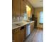Kitchen with wood look flooring, light wood cabinets, white countertops and stainless dishwasher at 1618 California St, Columbus, IN 47201
