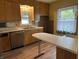 Bright kitchen featuring light wood cabinets, white countertops, and wood look flooring at 1618 California St, Columbus, IN 47201