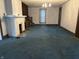 Spacious living room featuring carpet, a fireplace, built-in shelves, and staircase at 1618 California St, Columbus, IN 47201
