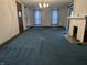 Spacious living room featuring carpet, a fireplace, and windows with curtains at 1618 California St, Columbus, IN 47201