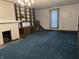 Spacious living room featuring carpet, a fireplace, built-in shelves, and staircase at 1618 California St, Columbus, IN 47201