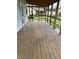 Large porch with wood flooring provides ample space for entertaining guests at 1618 California St, Columbus, IN 47201