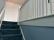 Carpeted staircase with painted railing and decorative wallpaper at 1618 California St, Columbus, IN 47201