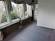 Enclosed sunroom featuring many windows with curtains and purple carpet at 1618 California St, Columbus, IN 47201