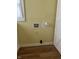 Close-up of wall showing hookups for a washer, dryer and an electrical outlet at 1618 California St, Columbus, IN 47201