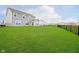 Large, grassy backyard with a black metal fence, perfect for outdoor activities at 17951 Paula Walk, Westfield, IN 46074
