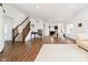 Spacious living room with laminate floors, an open floor plan, and views into the dining area and kitchen at 17951 Paula Walk, Westfield, IN 46074