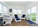 Inviting sunroom with large windows and comfortable wicker furniture, offering a relaxing space at 17951 Paula Walk, Westfield, IN 46074