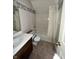 Small bathroom with linoleum floors and seashell wallpaper at 1915 Seaport Dr, Indianapolis, IN 46240