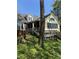 Charming yellow home featuring a screened porch and wooden deck, perfect for outdoor entertaining at 1915 Seaport Dr, Indianapolis, IN 46240