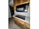 Kitchen featuring wood cabinets, granite countertops, and stainless steel appliances at 1915 Seaport Dr, Indianapolis, IN 46240