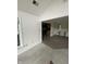 View of the living room with carpeted floors, adjacent to the kitchen with tile flooring at 1915 Seaport Dr, Indianapolis, IN 46240