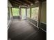 Spacious screened porch with a wood paneled ceiling, wood flooring, and a pleasant view of the outside at 1915 Seaport Dr, Indianapolis, IN 46240