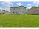 Exterior view of a two-story home with light siding and a spacious backyard at 1966 Freedom Ct, Greenfield, IN 46140