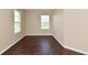 Neutral bedroom with a wood floor and two windows that offer natural light at 1966 Freedom Ct, Greenfield, IN 46140