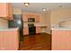 Charming kitchen featuring wooden cabinets and modern black appliances, providing functionality and style at 1966 Freedom Ct, Greenfield, IN 46140