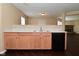 Open-concept kitchen with wood cabinets and a black dishwasher, ideal for modern living and entertaining at 1966 Freedom Ct, Greenfield, IN 46140