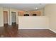 Open-concept kitchen with wood cabinets and dark wood-look flooring, offering a modern design at 1966 Freedom Ct, Greenfield, IN 46140
