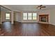 Open living room showcasing hardwood floors, fireplace, and ample natural light, ideal for relaxing or entertaining at 1966 Freedom Ct, Greenfield, IN 46140