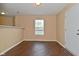 Bright living room featuring hardwood floors, a neutral color palette, and a view of the entry door at 1966 Freedom Ct, Greenfield, IN 46140