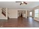 Open living room highlighting a staircase, hardwood floors, and seamless flow to kitchen, perfect for modern living at 1966 Freedom Ct, Greenfield, IN 46140