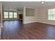 Spacious living room featuring hardwood floors, a fireplace, and abundant natural light through large windows at 1966 Freedom Ct, Greenfield, IN 46140