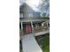 Stylish home featuring a covered porch, a bright red front door, and modern architectural details at 209 N Beville N Ave, Indianapolis, IN 46201