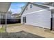View of the side and back of the house with a brick patio and fenced yard at 213 S State Ave, Indianapolis, IN 46201