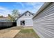 Backyard featuring a detached garage, fenced yard and sliding door access to house at 213 S State Ave, Indianapolis, IN 46201