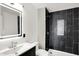 Stylish bathroom with LED mirror and walk in shower with black tile at 213 S State Ave, Indianapolis, IN 46201