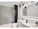 Modern bathroom with LED mirror, double sinks, gray tiling, and black accent tiles in the shower at 213 S State Ave, Indianapolis, IN 46201