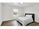 Bright bedroom with a large window and wood floors at 213 S State Ave, Indianapolis, IN 46201