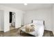 Bright bedroom with en-suite bathroom, wood floors, white walls, and comfortable bed at 213 S State Ave, Indianapolis, IN 46201
