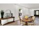Stylish dining area with wood table, modern lighting, and a view of the kitchen and living area at 213 S State Ave, Indianapolis, IN 46201