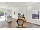 Stylish dining area with wood table, modern lighting, and a view of the kitchen and outdoor area at 213 S State Ave, Indianapolis, IN 46201
