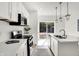 Bright kitchen featuring stainless steel appliances, ample counter space, island and backyard access at 213 S State Ave, Indianapolis, IN 46201