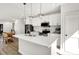Beautiful open concept kitchen featuring stainless steel appliances, white cabinets, island and modern lighting at 213 S State Ave, Indianapolis, IN 46201