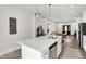 Bright kitchen with island, stainless appliances and modern lighting; open to the living area at 213 S State Ave, Indianapolis, IN 46201