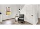 Cozy room with hardwood floors, a stylish chair, and large window providing plenty of natural light at 213 S State Ave, Indianapolis, IN 46201
