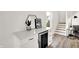 Stylish living room features a wine cooler, modern decor, and staircase view at 213 S State Ave, Indianapolis, IN 46201