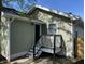 Home featuring a wood deck, green siding and black trim on a sunny day at 2141 Napoleon St, Indianapolis, IN 46203