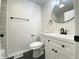 Modern bathroom boasts a new vanity, toilet, and a stylish round mirror with updated fixtures at 2141 Napoleon St, Indianapolis, IN 46203
