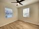 Bright bedroom featuring updated floors, a ceiling fan, and natural light from two windows at 2141 Napoleon St, Indianapolis, IN 46203
