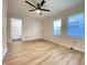 Light and airy bedroom featuring laminate flooring, two windows and attached bathroom at 2141 Napoleon St, Indianapolis, IN 46203