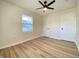 The bright bedroom features updated floors, a ceiling fan, closet doors, and natural light at 2141 Napoleon St, Indianapolis, IN 46203