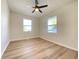 Bright bedroom featuring updated floors, a ceiling fan, and natural light from two windows at 2141 Napoleon St, Indianapolis, IN 46203